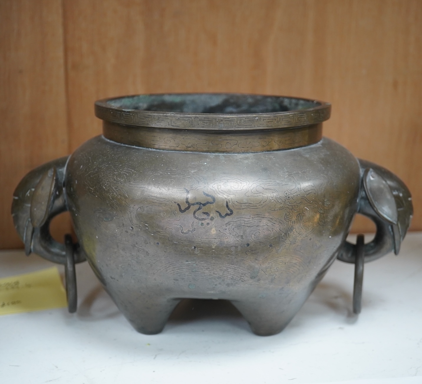 A large Chinese silver inlaid bronze elephant handled censer, signed Sishou, 19th century, 16cms high, 29cm wide. Condition - fair